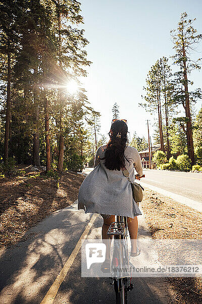 USA  California  Tahoe City  Rear view of woman riding bicycle on bike lane