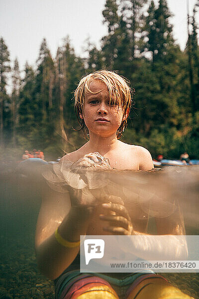 USA  California  Portrait of boy (8-9) in Truckee river