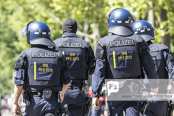 Police officers wearing helmets and protective equipment on their way to the scene  Stuttgart  Baden-Württemberg  Germany  Europe