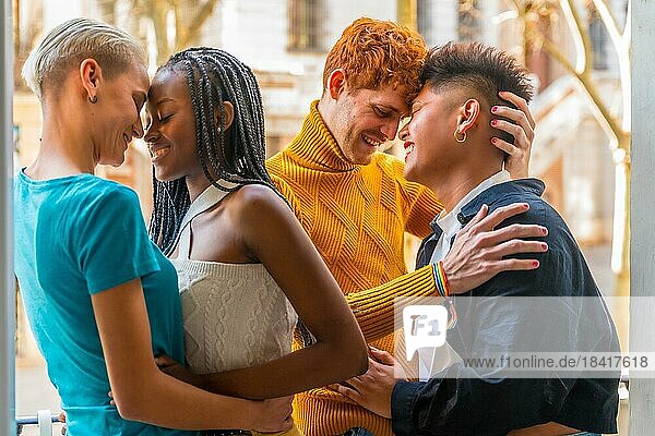 Portrait of couples of gay boys and lesbian girls embraced giving each other a kiss  lgtb concept