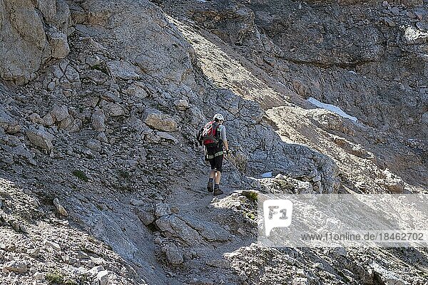 Tourist crossing the via ferrata trail with equipment in the dolomites. Dolomites  Italy  Dolomites  Italy  Europe