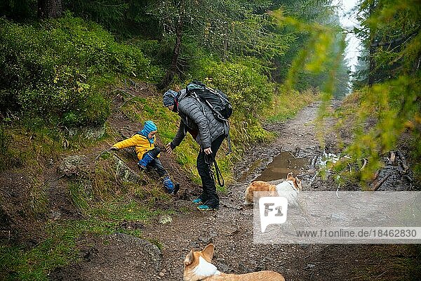 The child slipped and fell on the sloping  wet ground. Polish mountains  Poland  Europe