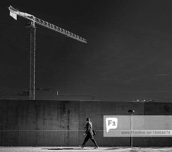 Schwarz-Weiß Fotografie  Baukran hinter einer Betonmauer  Friedrichshain  Berlin  Deutschland  Europa
