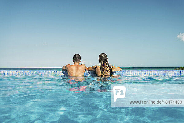 Boyfriend and girlfriend enjoying together in swimming pool