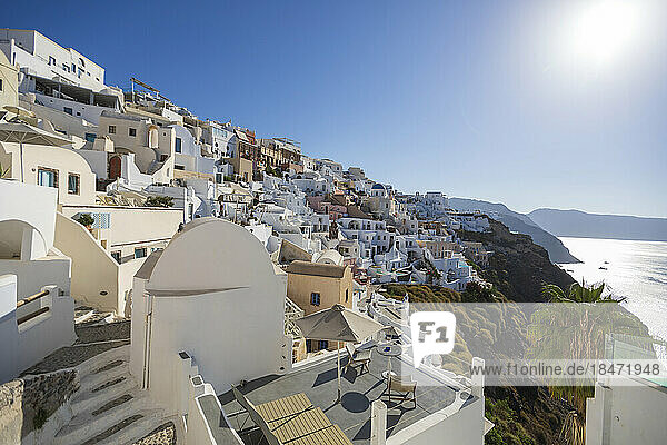 Whitewashed houses on hill under sky