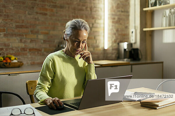 Freelancer working on laptop at desk
