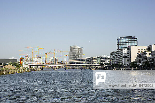 Germany  Hamburg  Elbe river flowing through HafenCity with bridge and large construction site in background