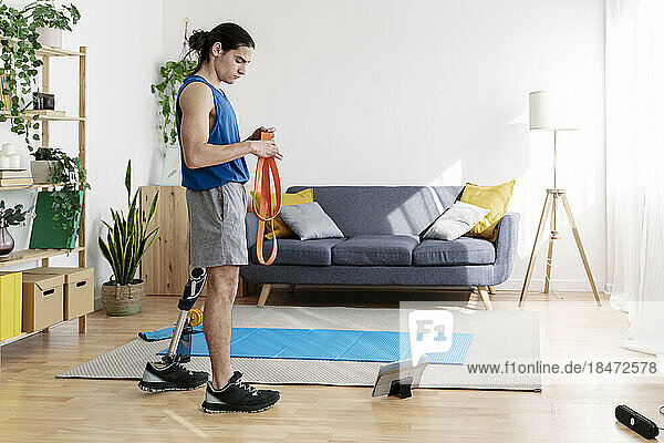 Young man with disability preparing for exercise at home