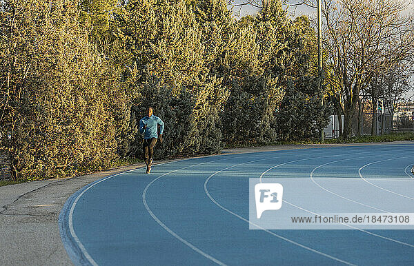 Athlete running on sports track