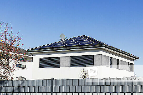 Germany  North Rhine Westphalia  Cologne  Clear sky over modern houses with solar roof panels