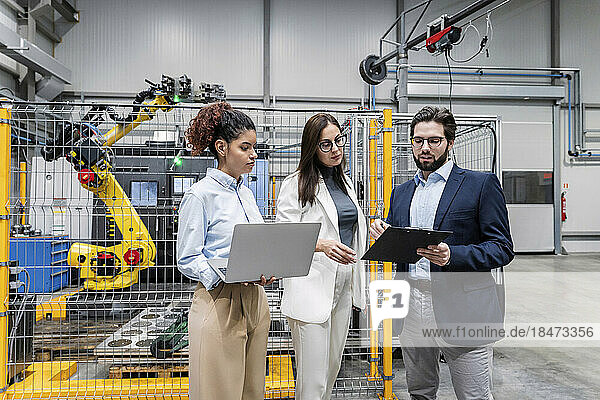 Business people having discussion in factory