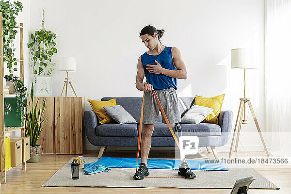 Young man with disability exercising at home