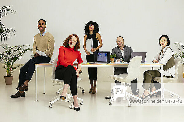 Multiracial business people sitting in meeting room at office