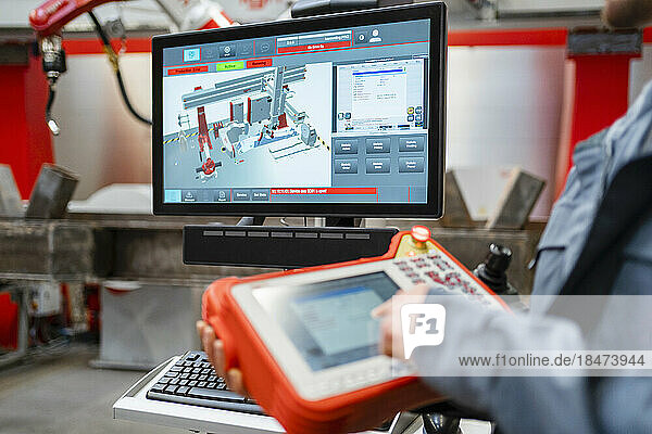 Monitor screen with engineer operating controller in industry
