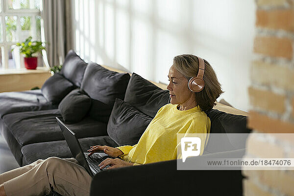 Freelancer working on laptop in living room