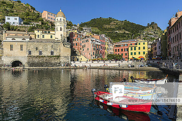 Italy  Liguria  Vernazza  Edge of coastal town along Cinque Terre with boats moored in foreground
