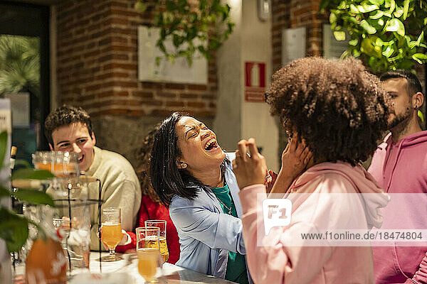Happy woman enjoying with friends at restaurant