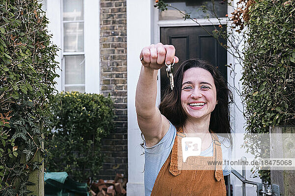 Happy woman showing new home keys