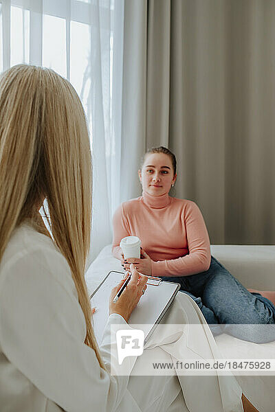 Patient looking at psychologist in clinic