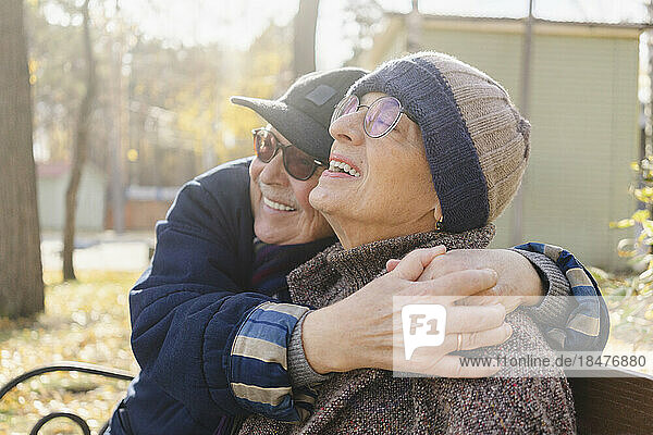 Happy senior woman enjoying with man at autumn park