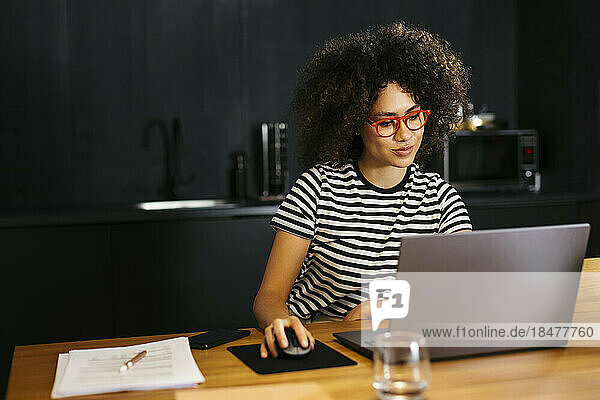 Freelancer working on laptop at table