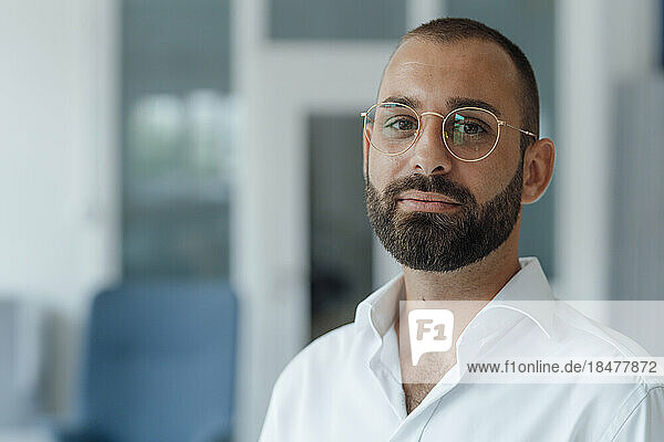 Confident businessman wearing eyeglasses at home office