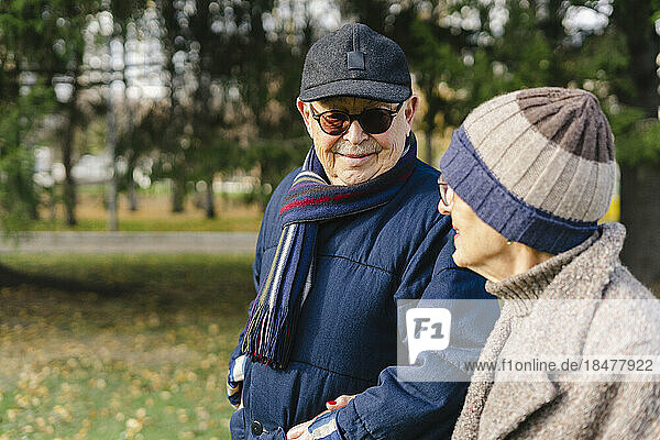 Senior couple wearing warm clothing at autumn park