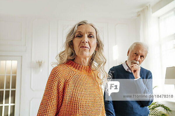 Senior woman and man standing together at home