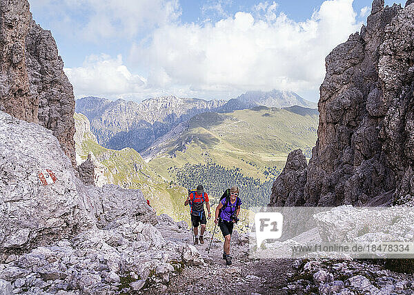 Man and woman hiking at Forcella Della Roa  Dolomites  Italy