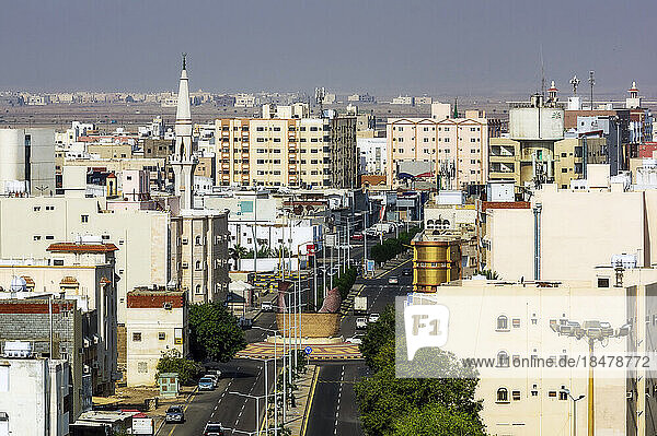 City street amidst buildings on sunny day