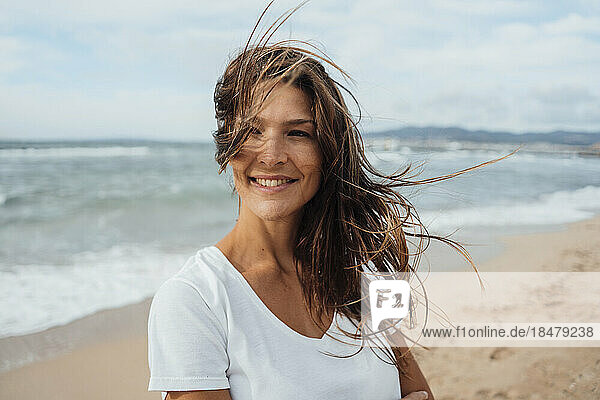 Happy woman with long hair spending leisure time at beach
