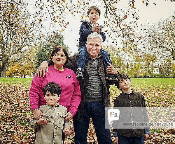 Grandparents with grandsons standing at park