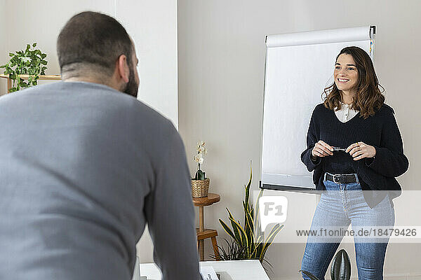 Businesswoman having discussion with colleague at office