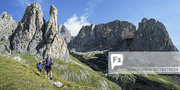 Man and women hiking on mountains at Cascate delle Comelle  Dolomites  Italy