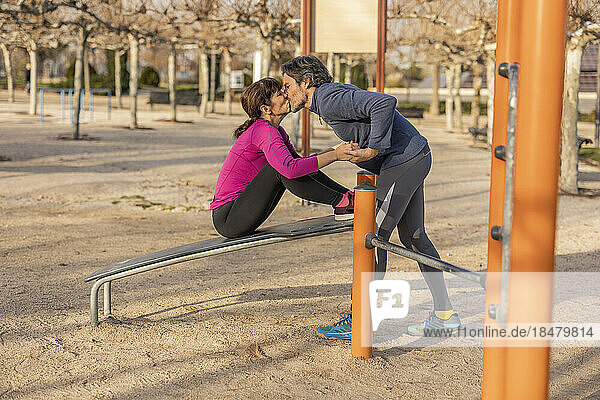Mature couple kissing each other in park
