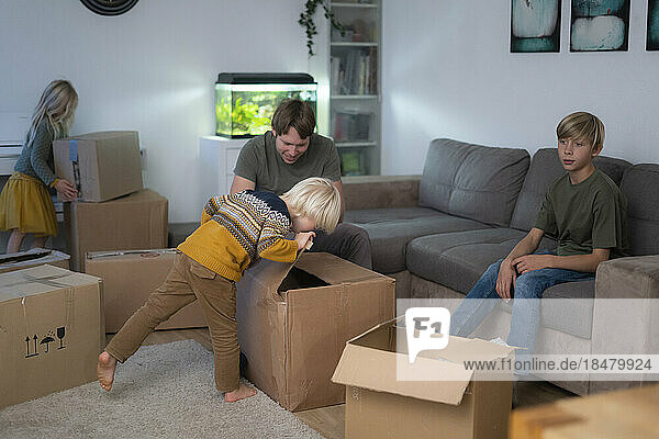 Children and father packing at home