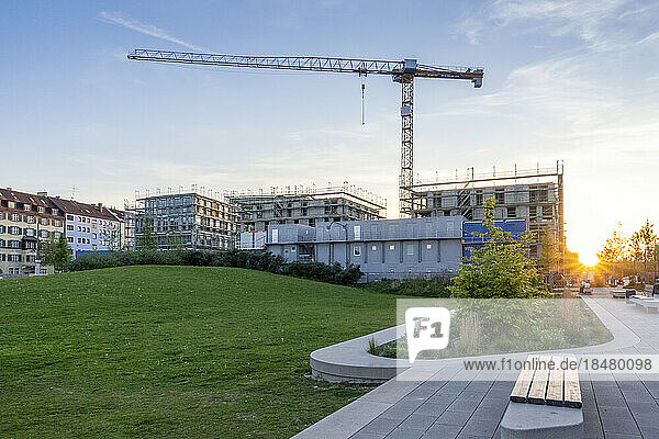 Germany  Bavaria  Munich  Construction site of modern apartment building at sunset