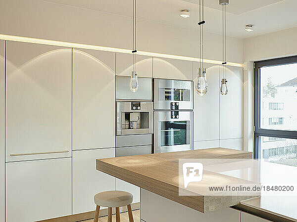Pendant lights on kitchen island in modern apartment