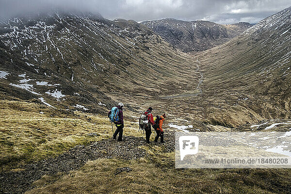 Tranquil view of hikers walking on mountain  Glencoe  Scotland