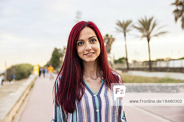 Happy redhead woman at promenade