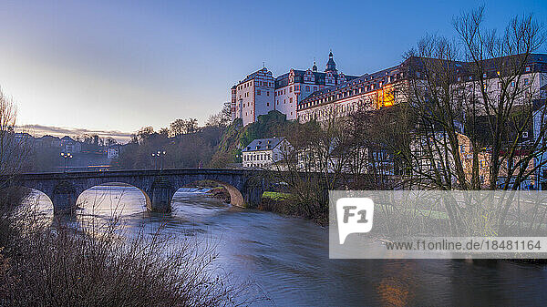 River in front of Weilburg Castle at sunrise