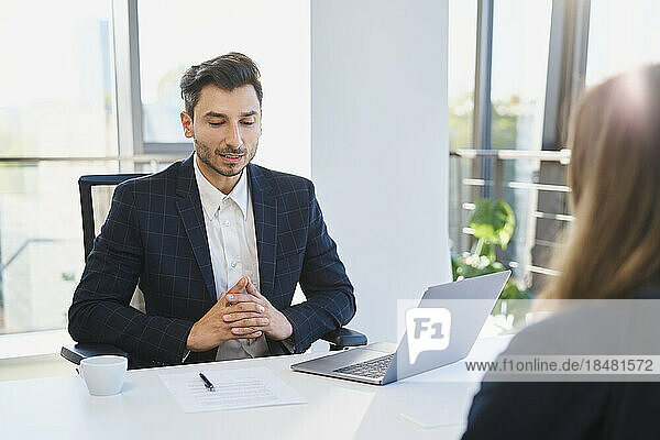 Recruiter talking to candidate in interview at office