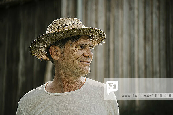 Smiling senior man wearing straw hat