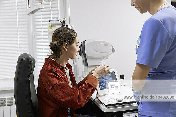 Patient looking at medical results after check up in clinic