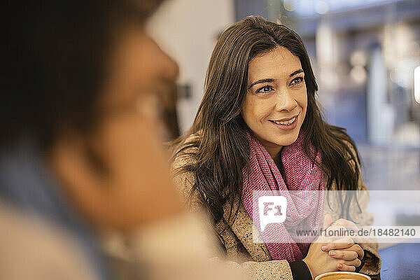 Smiling beautiful woman sitting in cafe