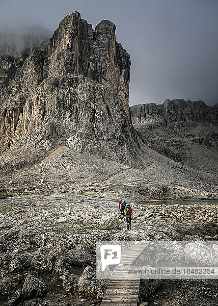 Man and woman hiking at Cima Pisciadu  Dolomites  Italy