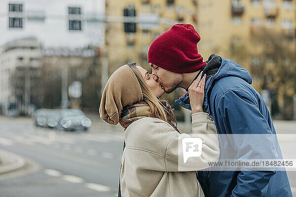 Romantic couple kissing each other at street