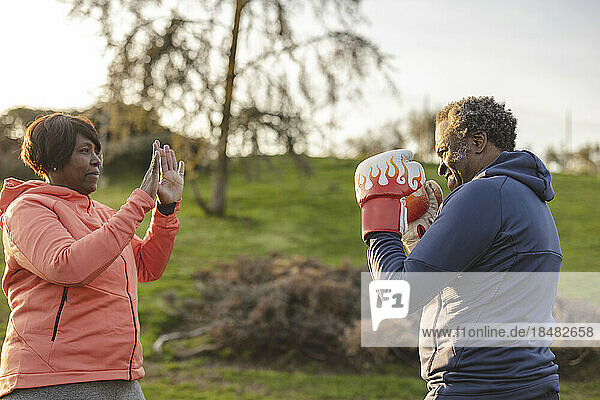 Couple practicing boxing at park