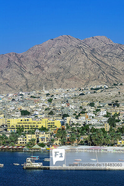 Aqaba city near mountain range on sunny day