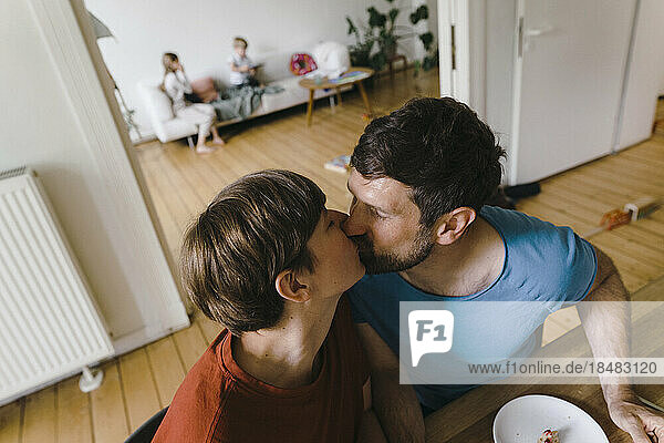 Mature romantic couple kissing each other at home